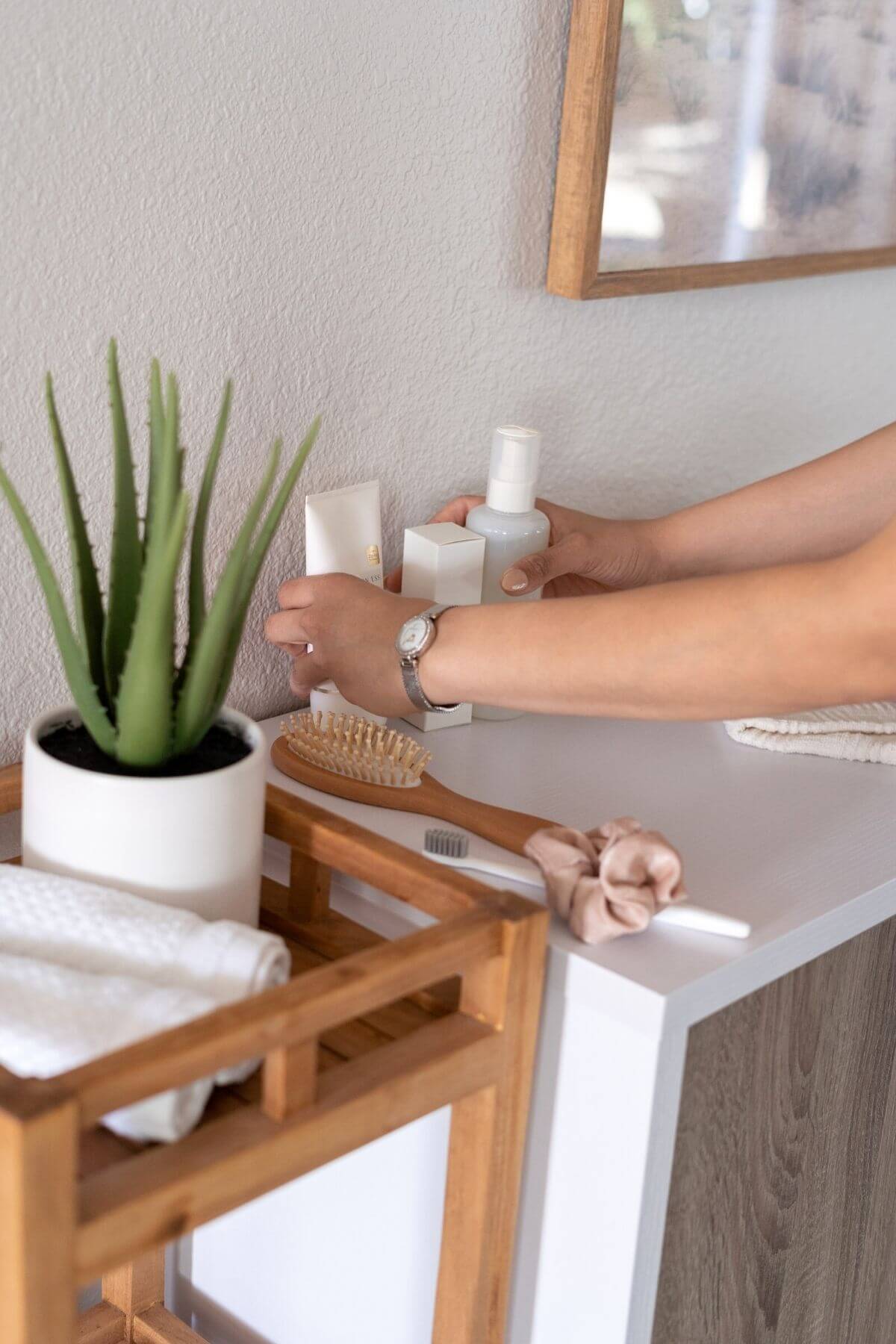 woman tidying bathroom counter