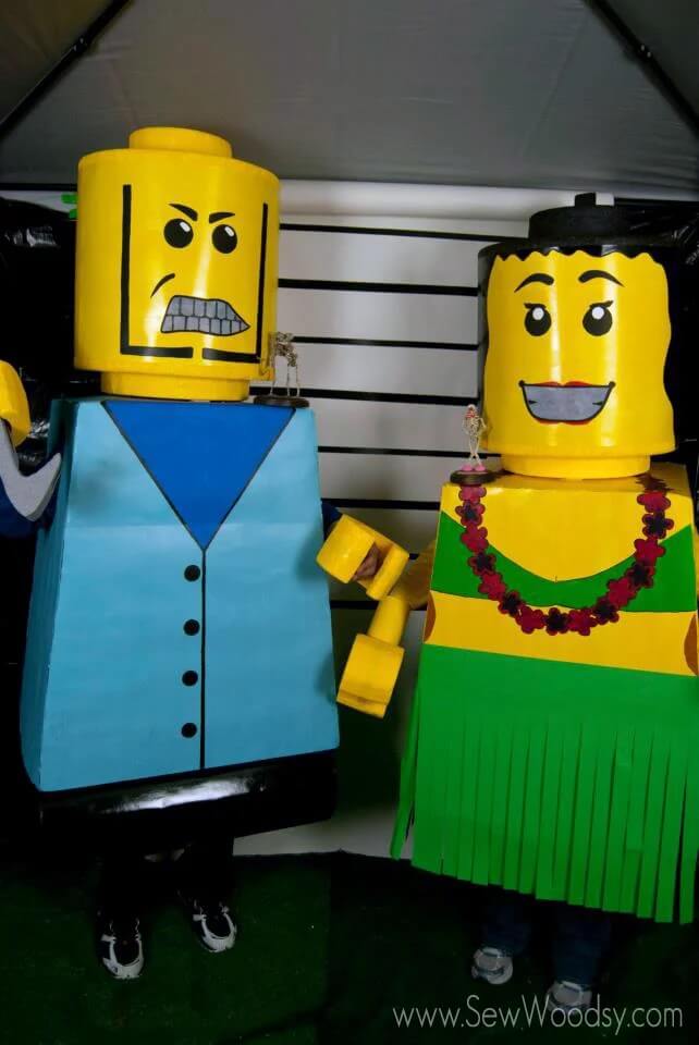 man and woman dressed as giant lego people