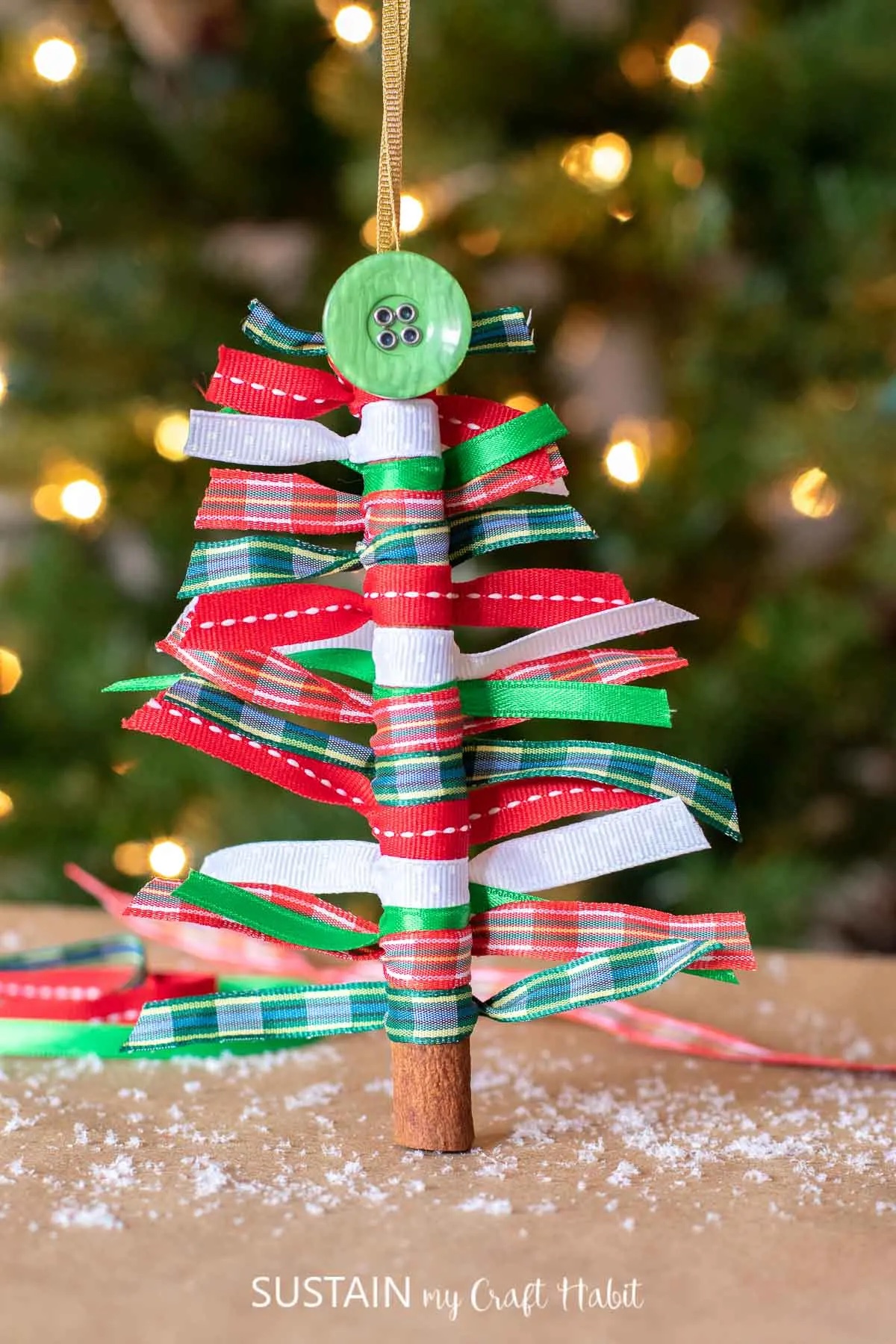 diy ribbon christmas tree ornament made from a cinnamon stick.