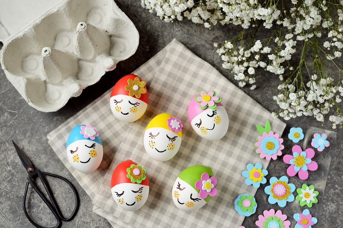 decorated easter eggs with little caps and faces