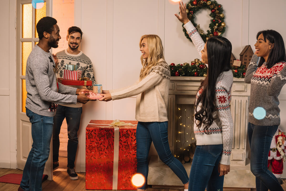 group of friends exchanging christmas gifts