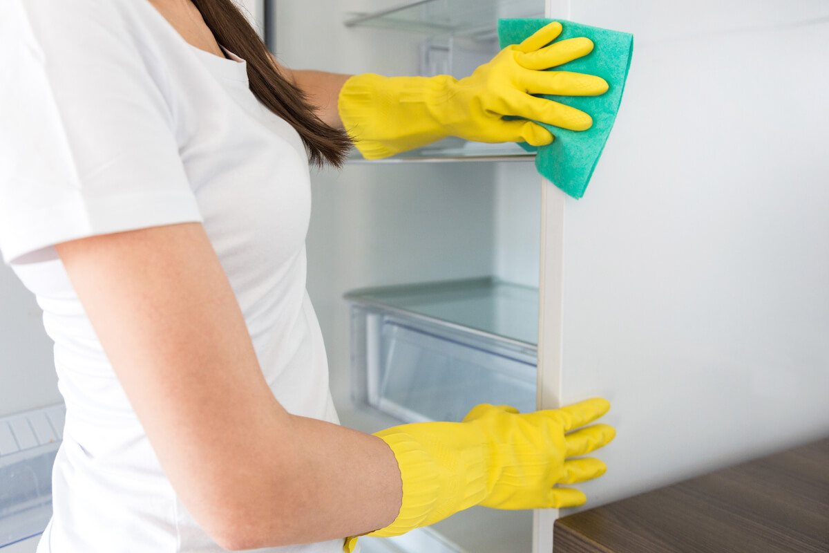 woman cleaning a refrigerator