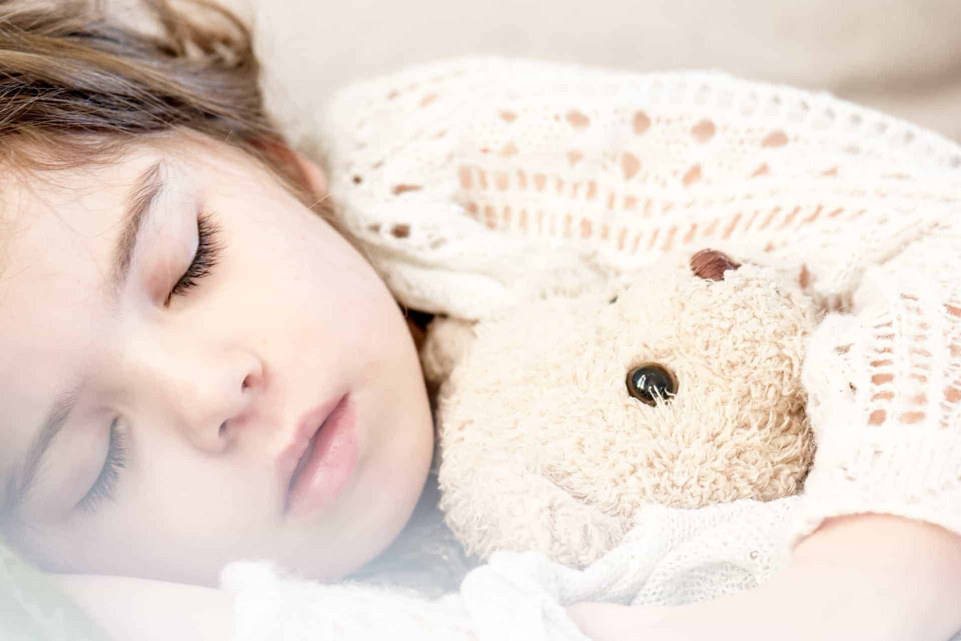 child sleeping with teddy