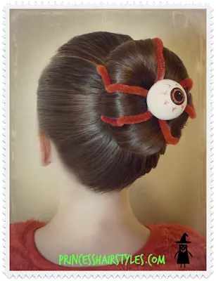 silly eyeball hairstyle with a bun and pipe cleaners.