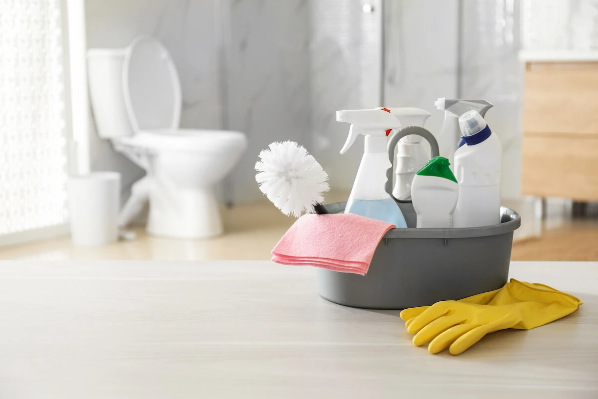 bathroom cleaning supplies sitting on bathroom floor