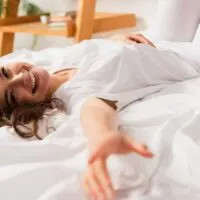 woman relaxing on her bed on a lazy weekend